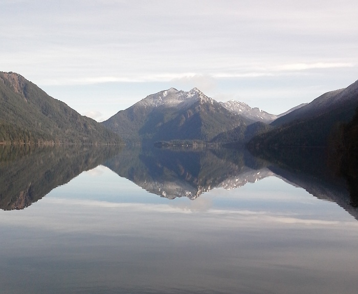 The Olympic Mountains reflected in the calm waters of Lake Crescent